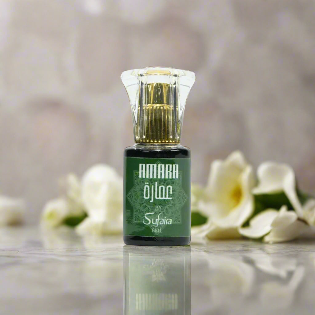 attar bottle with green label on a floral background