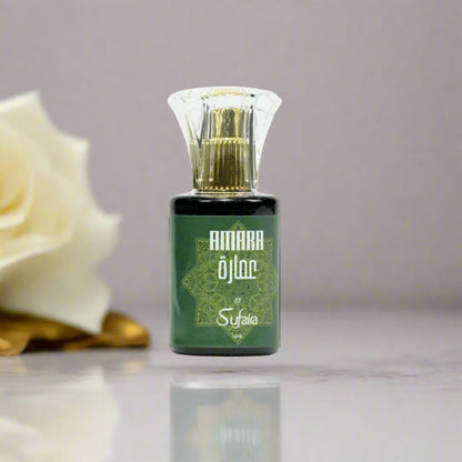 Green perfume bottle with gold cap on a gray background