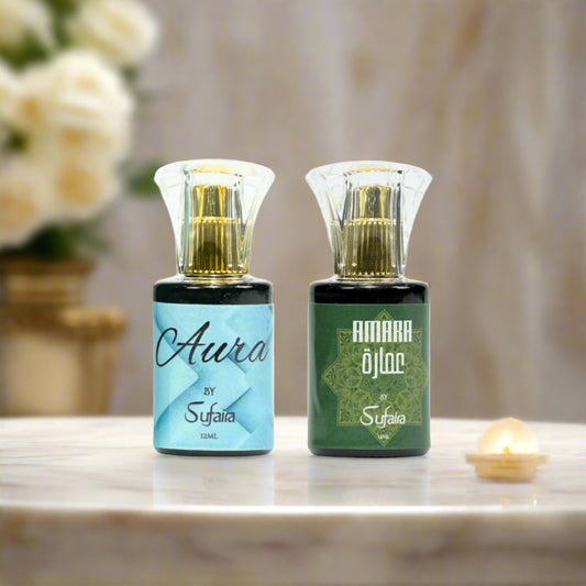 Two attar bottles labeled 'Aura by Sufaira' and 'Amara by Sufaira' on a cream background.