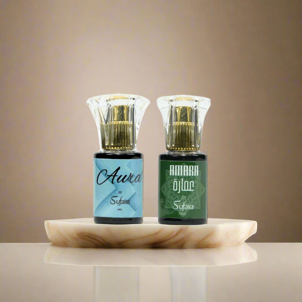 Two small bottles labeled 'Aura' and 'Amara' by Sufaira on a cream background.