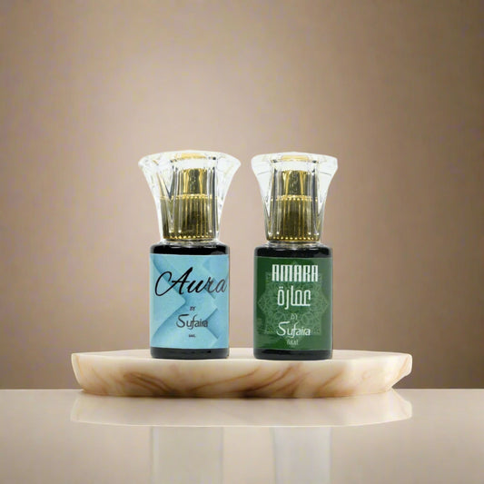 Two small bottles labeled 'Aura' and 'Amara' by Sufaira on a cream background.