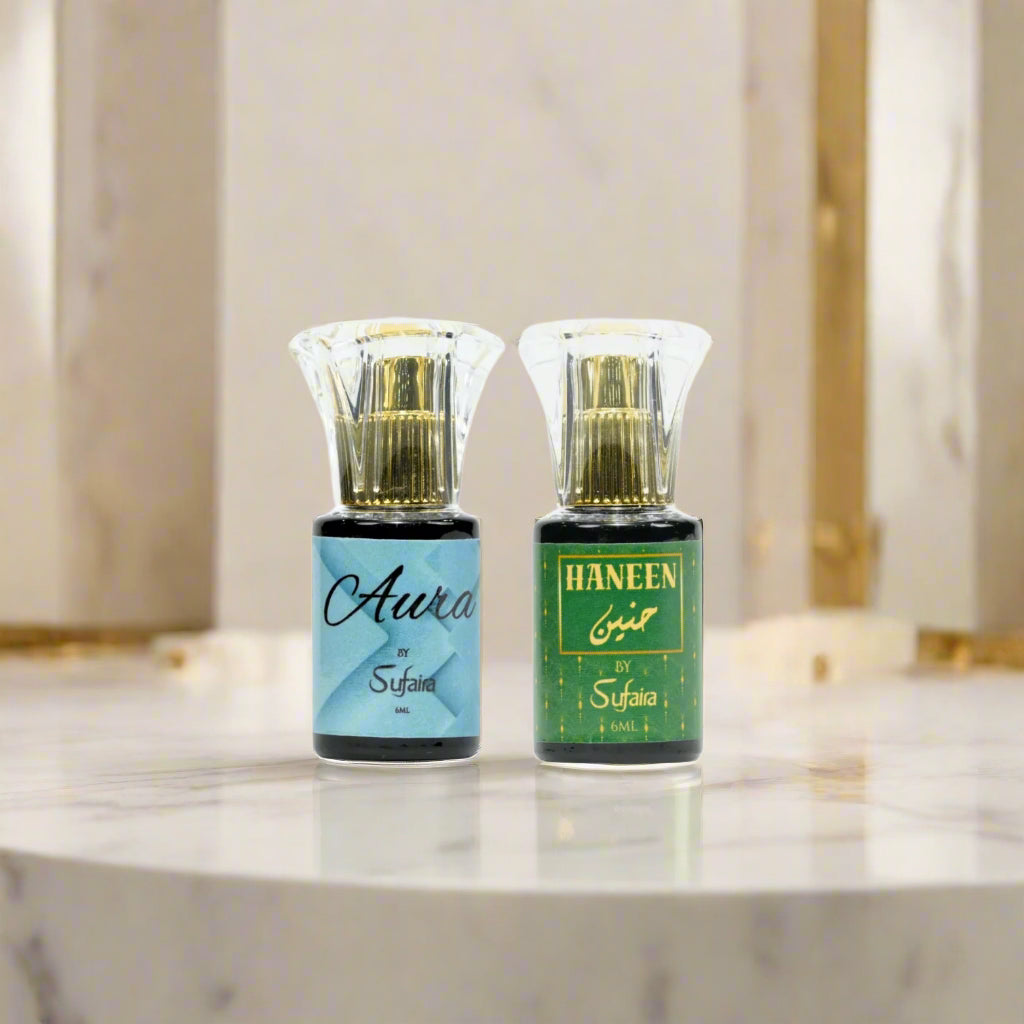Two perfume bottles labeled 'Aura' and 'Haneen' by Sufaira 