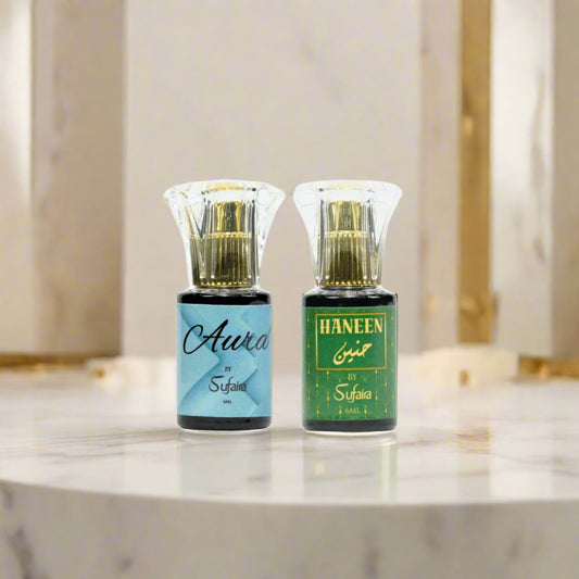Two perfume bottles labeled 'Aura' and 'Haneen' by Sufaira 
