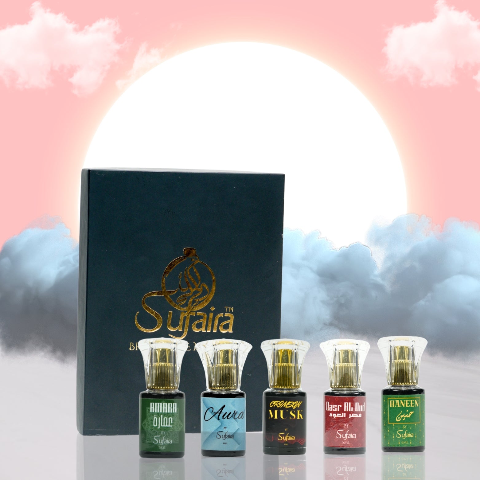 Set of Sufaira perfume bottles with a decorative box against a cloudy sky background
